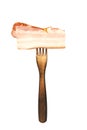 a piece of appetizing smoked bacon on a wooden fork isolated on a white Royalty Free Stock Photo