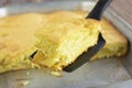 A piece of apple pie is on the blade for cake. Closeup.