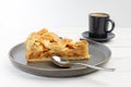 Piece of an apple pie with ice cream and cup of coffee espresso on white wooden table Royalty Free Stock Photo