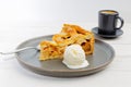 Piece of an apple pie with ice cream and cup of coffee espresso on white wooden table Royalty Free Stock Photo