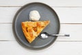 Piece of an apple pie with ice cream on white wooden table. Royalty Free Stock Photo