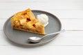 Piece of an apple pie with ice cream on white wooden table. Royalty Free Stock Photo