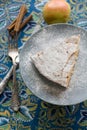 A piece of apple pie plate lying on gray, cinnamon sticks, apple Royalty Free Stock Photo