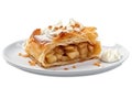 A piece of apple strudel filled with apple pieces on a plate, decorated with cream and icing sugar Royalty Free Stock Photo