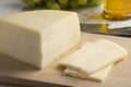 Piece of artisanal semi soft Italian Bel Paese cheese and slices Royalty Free Stock Photo