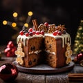 Piece of baked Christmas cake decorated with gingerbread men and cranberries