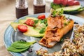 A piece of baked red fish with a side dish of sprouts and avocado salad. Macrobiotic food concept. Healthy food Royalty Free Stock Photo