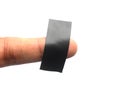 Piece of black electrical insulation tape on finger