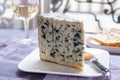 Piece of Bleu de Laqueuille semi-hard AOP French blue cheese made from raw cow milk