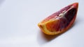 Piece of blood orange on a white plate , close-up