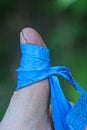 a piece of blue dirty electrical tape wound around a finger on a hand