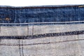 Piece of blue jeans fabric isolated on white background. Rough uneven edges. Denim jeans torn Royalty Free Stock Photo