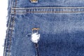 Piece of blue jeans fabric with ripped of back pocket Royalty Free Stock Photo