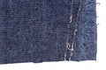 Piece of blue jeans fabric with ripped of back pocket Royalty Free Stock Photo