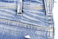 Piece of blue jeans fabric with ripped of back pocket Royalty Free Stock Photo