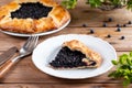 Piece of blueberry pie on a plate on wooden table Royalty Free Stock Photo