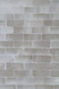 Piece of brick wall under plaster. Brick block wall background with reinforcing mesh for wall plastering. White gray stucco Royalty Free Stock Photo