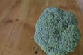 Piece of broccoli on rustic wooden table