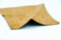 Piece of brown leather and suede cut on white background. Concept and idea of fine leather crafting, handmade, handcrafted
