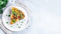 Piece of brunch egg frittata with vegetables on plate, horizontal, top view, copy space Royalty Free Stock Photo