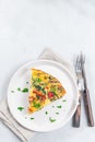 Piece of brunch egg frittata with vegetables on plate, vertical, top view, copy space Royalty Free Stock Photo