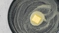 Piece of butter on a hot frying pan, flat lay Royalty Free Stock Photo