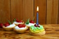 A piece of cake with a burning candle for a birthday Royalty Free Stock Photo