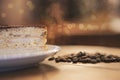 Piece cake and coffee beans on a wooden board