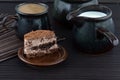 Piece of cake, cup of cofee and fresh milk on wooden table Royalty Free Stock Photo