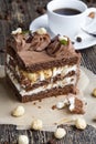 a piece of cake made of chocolate sponge cake cream and caramel with hazelnuts Royalty Free Stock Photo