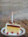 Piece of cake `Napoleon` with lighted candles. Birthday. Side view. Copy space. Royalty Free Stock Photo