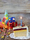 Piece of cake `Napoleon` with lighted candles. Birthday. Side view. Copy space. Royalty Free Stock Photo