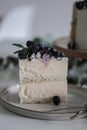 A piece of cake on a plate with blueberries and blueberries on the table Royalty Free Stock Photo