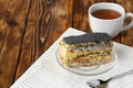 Piece of cake with poppy seeds on glass plate close up