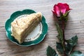 A piece of cake with a rose flower on a light background Royalty Free Stock Photo