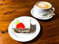 Piece of carrot cake and cappuccino on wooden table Royalty Free Stock Photo