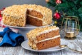 Piece of Carrot cake with cream cheese frosting and walnuts, Christmas decoration on background, horizontal Royalty Free Stock Photo