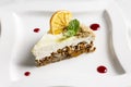 The piece of carrot cake with cream, nuts and dried orange Royalty Free Stock Photo
