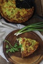 A piece of casserole of zucchini with herbs on a wooden table Royalty Free Stock Photo