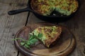 A piece of casserole of zucchini with herbs on a wooden table Royalty Free Stock Photo