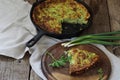 A piece of casserole of zucchini with herbs on a wooden table Royalty Free Stock Photo