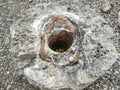 A piece of ceramic pipe at an archaeological site.