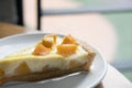 A piece of cheese cake tart with fresh mango, delicious mango ta