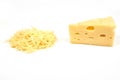 Piece of cheese and heap of grated cheese, isolated on white background.