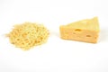 Piece of cheese and heap of grated cheese, isolated on white background.