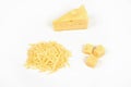 Piece of cheese and heap of grated cheese, isolated on white background.