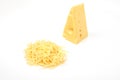 Piece of cheese and heap of grated cheese, isolated on white background.