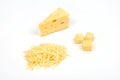 Piece of cheese and heap of grated cheese, isolated on white background.