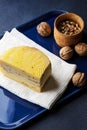 A piece of cheese served with walnuts on the blue tray Royalty Free Stock Photo