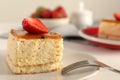 Piece of cheesecake with strawberry and fork on table, closeup Royalty Free Stock Photo